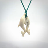 Hand carved natural double dolphin bone pendant. Hand made bone dolphin necklace, delivered with Express Courier. Hand crafted bone double dolphin pendant. Provided with an adjustable blue cord.